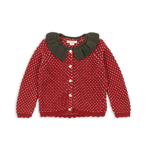 Red polka dot cardigan with a brown collar on a white background