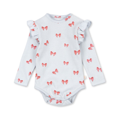 Baby bodysuit with ruffled sleeves and red bow pattern on a white background