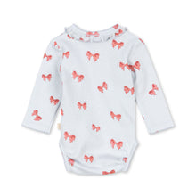Load image into Gallery viewer, White baby onesie with red bow pattern on a white background