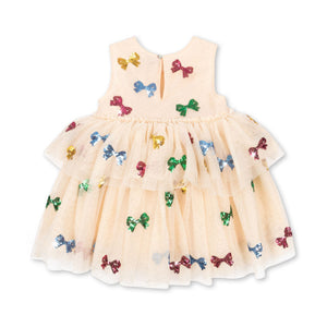 Beige dress with colorful bow patterns on a white background