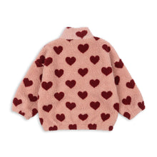 Load image into Gallery viewer, Pink fleece jacket with red heart patterns on a white background