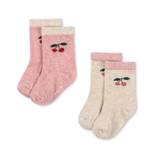 Two pairs of socks with cherry design on a white background