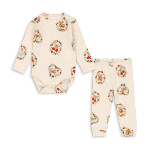 Floral baby bodysuit and pants set on a white background