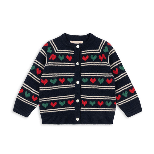 Navy cardigan with red and green heart patterns on a white background