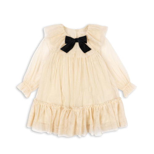 Cream-colored dress with a black bow on a white background