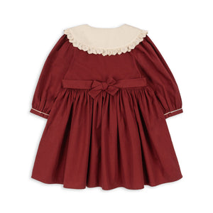 Red dress with a white collar on a white background
