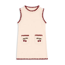 Load image into Gallery viewer, Cream-colored sleeveless top with red trim and cherry designs on a white background