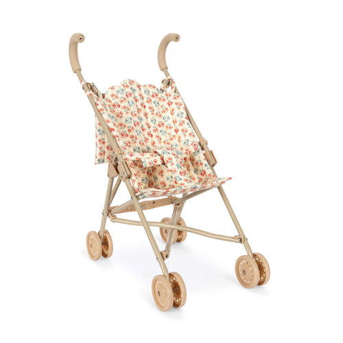 Miniature floral stroller on a white background