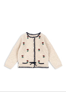 Beige cardigan with floral and bow pattern on a white background