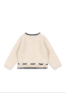 Beige sweater with black pattern on a white background