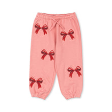 Load image into Gallery viewer, Pink pants with red bow designs on a white background