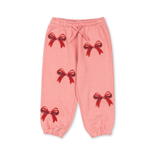 Pink pants with red bow designs on a white background