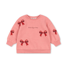 Load image into Gallery viewer, Pink sweatshirt with red bow designs on a white background
