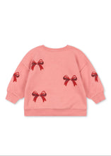 Load image into Gallery viewer, Pink sweatshirt with red bow designs on a white background