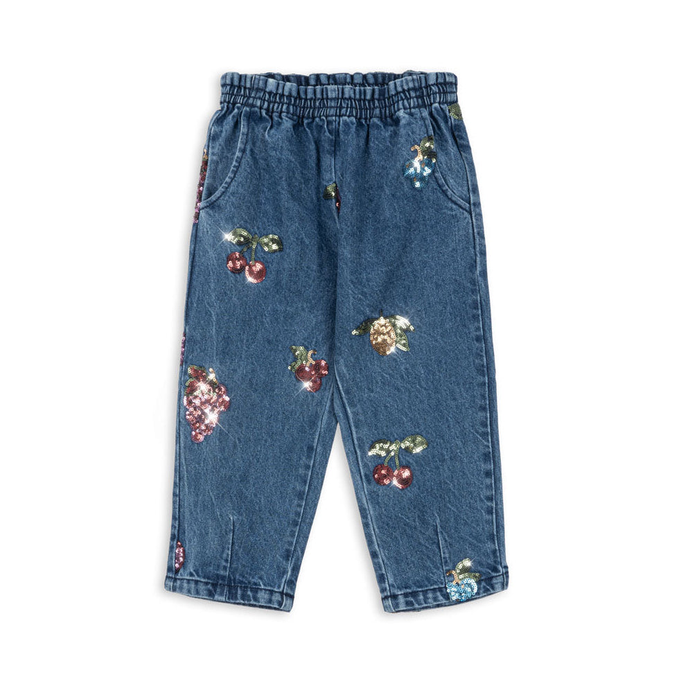 Blue jeans with fruit embroidery on a white background