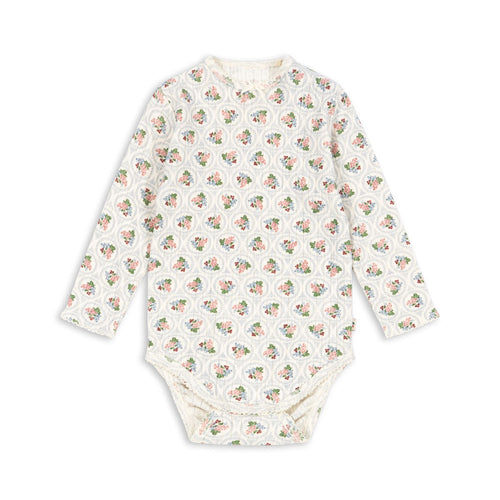 Baby bodysuit with long sleeves and a pattern on a white background