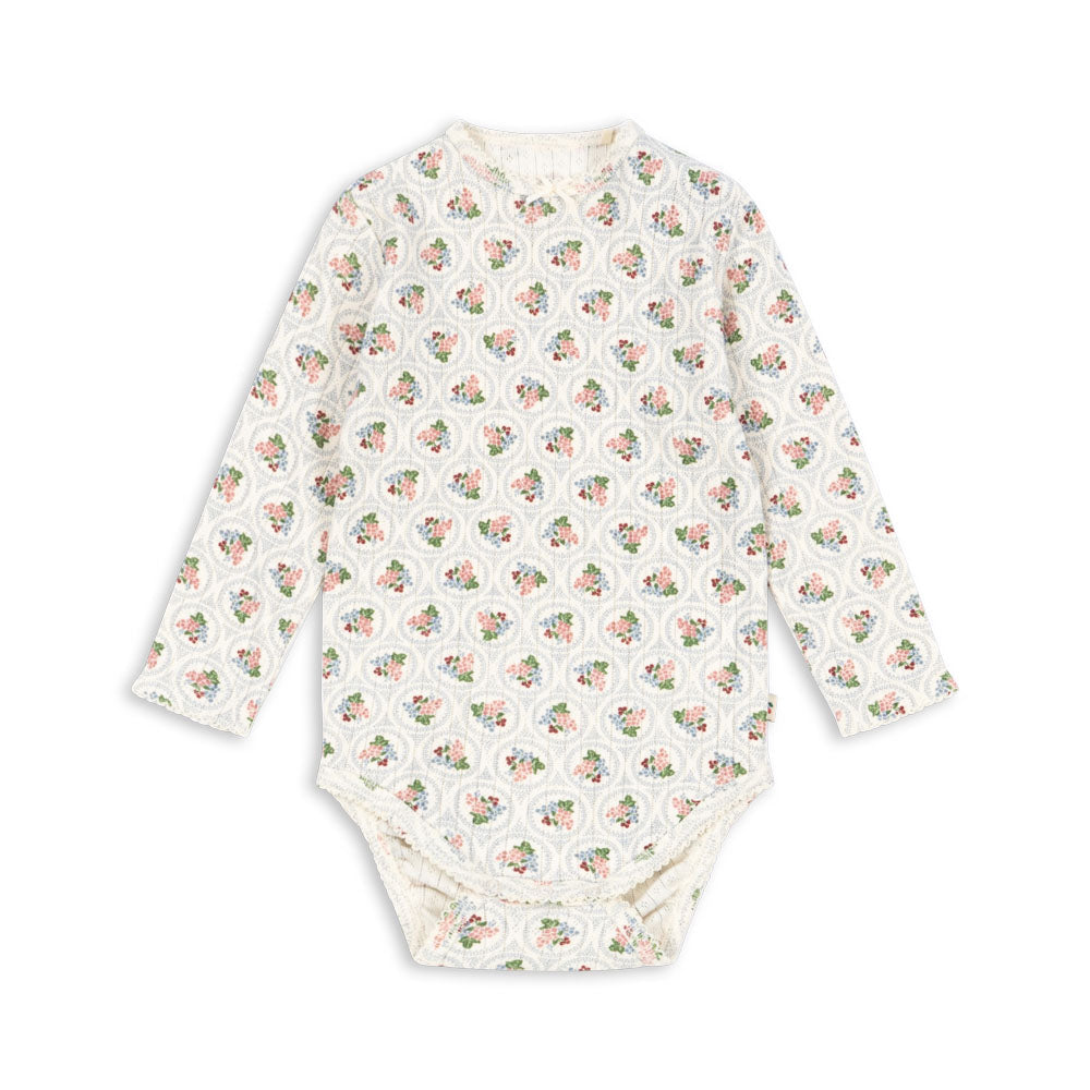 Baby bodysuit with long sleeves and a pattern on a white background