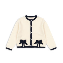 Load image into Gallery viewer, Cream-colored cardigan with black bow details on a white background