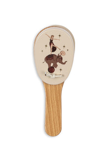 Hairbrush with circus-themed design on a white background