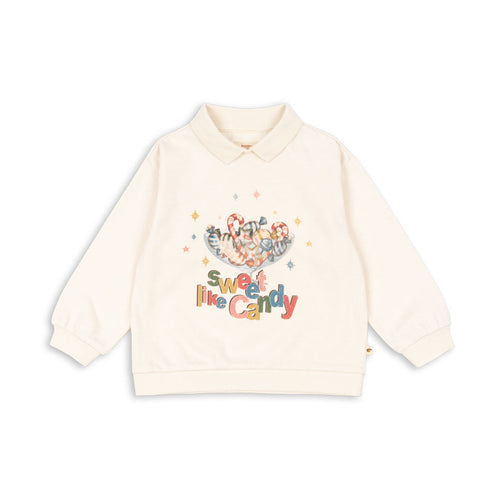 Beige sweatshirt with colorful text and graphics on a white background