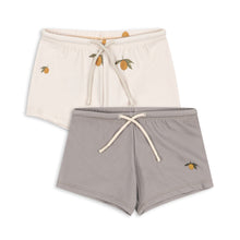 將圖片載入圖庫檢視器 Two pairs of shorts, one beige and one gray, with embroidered details on a white background.
