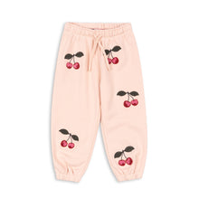 Load image into Gallery viewer, Pink sweatpants with cherry designs on a white background