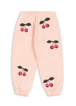 Load image into Gallery viewer, Pink sweatpants with cherry designs on a white background