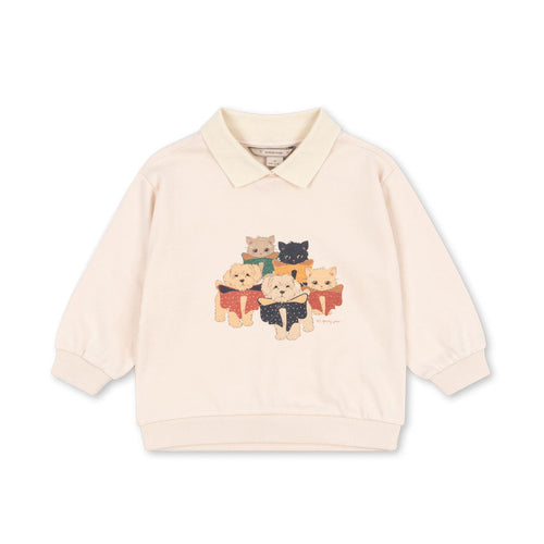 Beige sweater with cat design on a white background