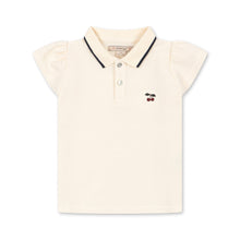 Load image into Gallery viewer, Beige polo shirt with black trim on a white background