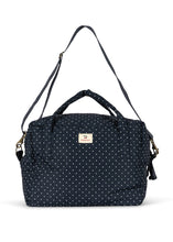 將圖片載入圖庫檢視器 A navy blue fabric bag with a white polka dot pattern, featuring top handles, a detachable shoulder strap, and a small beige brand label on the front.