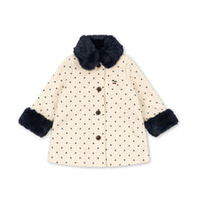 Load image into Gallery viewer, A cream-colored children's coat with small brown polka dots, featuring a dark navy faux-fur collar and cuffs, and a front button closure.
