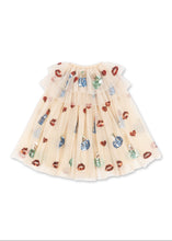 Load image into Gallery viewer, A baby girl's tulle tutu skirt in a warm cream color, decorated with a pattern of red lip prints and colorful Christmas ornaments, shown against a plain white background.