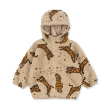 Load image into Gallery viewer, A beige sherpa zip-up hoodie with an all-over print of orange and black striped tigers and small gold stars, shown against a plain white background.