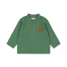 Load image into Gallery viewer, A green long-sleeve polo shirt for toddlers, featuring a small embroidered brown bear logo on the left chest, displayed on a clean white background.