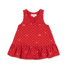 Load image into Gallery viewer, A sleeveless red children's dress with a V-neckline, ruffled hem, and an allover small white polka dot pattern, shown flat on a white background.