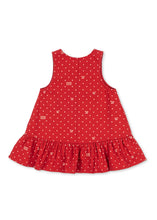 Load image into Gallery viewer, A sleeveless red dress for toddlers, featuring a white polka dot pattern with small beige rectangular accents, and a ruffled hem, shown flat on a white background.