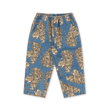 Load image into Gallery viewer, A pair of children's blue denim pants featuring an allover print of golden-brown tigers, displayed flat against a solid white background.
