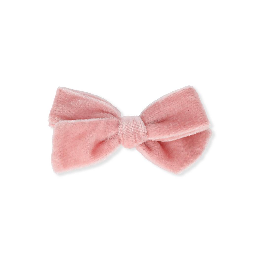 Pink velvet bow on a white background