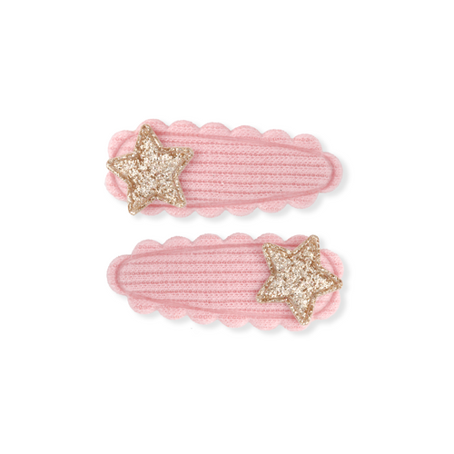 Two pink hair clips with gold star designs on a white background