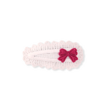 Load image into Gallery viewer, Pink knitted headband with a red bow on a white background
