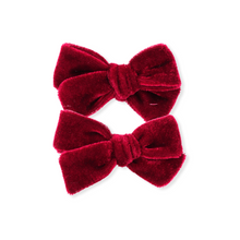 Load image into Gallery viewer, Two red velvet hair bows on a white background